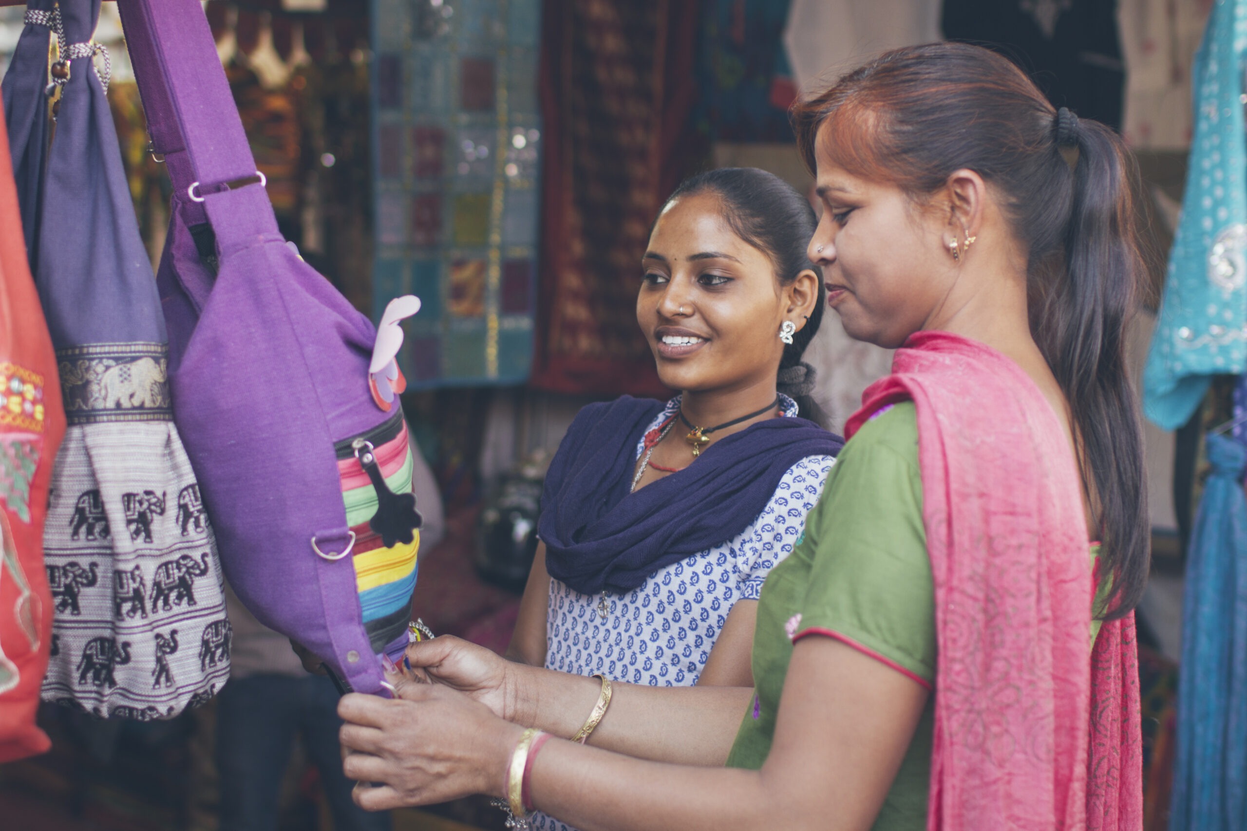 Indian ladies shopping together Field Manager dealing with frontline workers